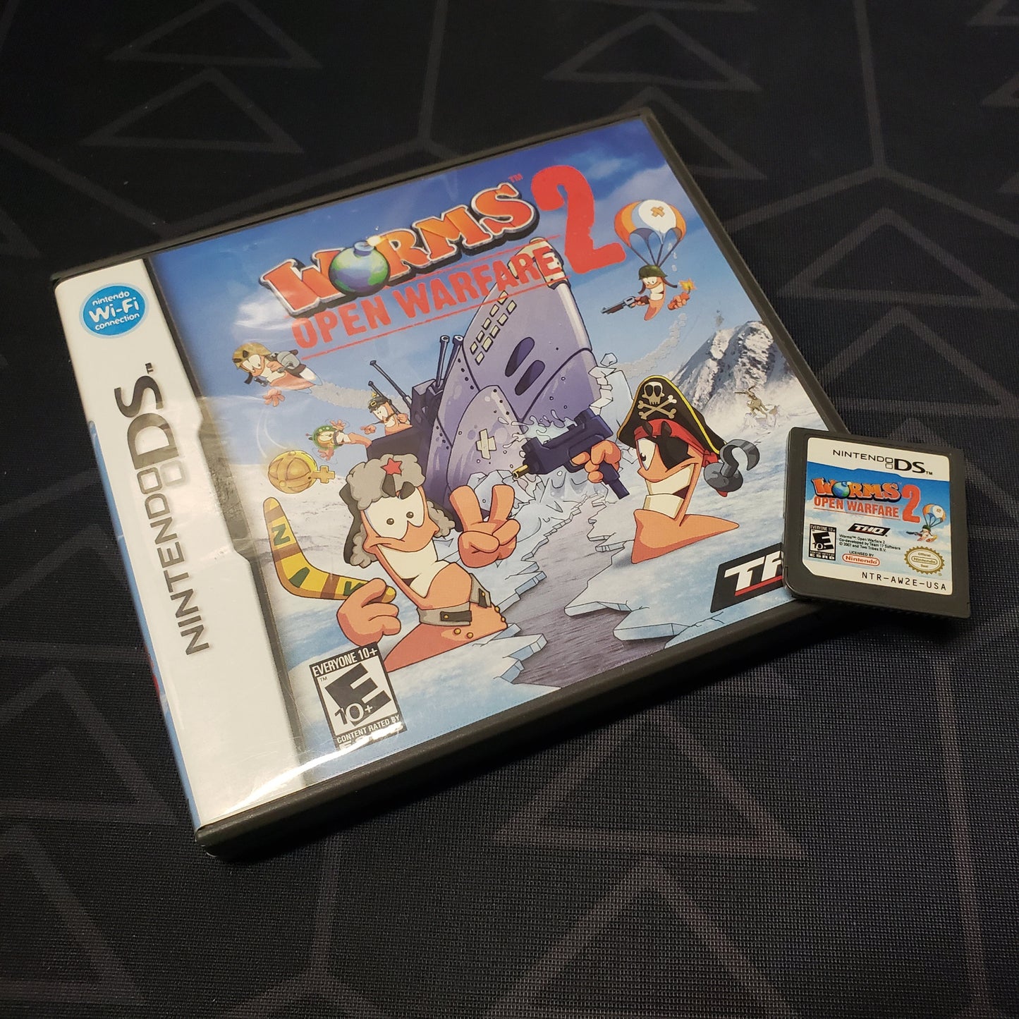 Image shows the case and cartridge for the video game Worms 2: Open Warfare for Nintendo DS