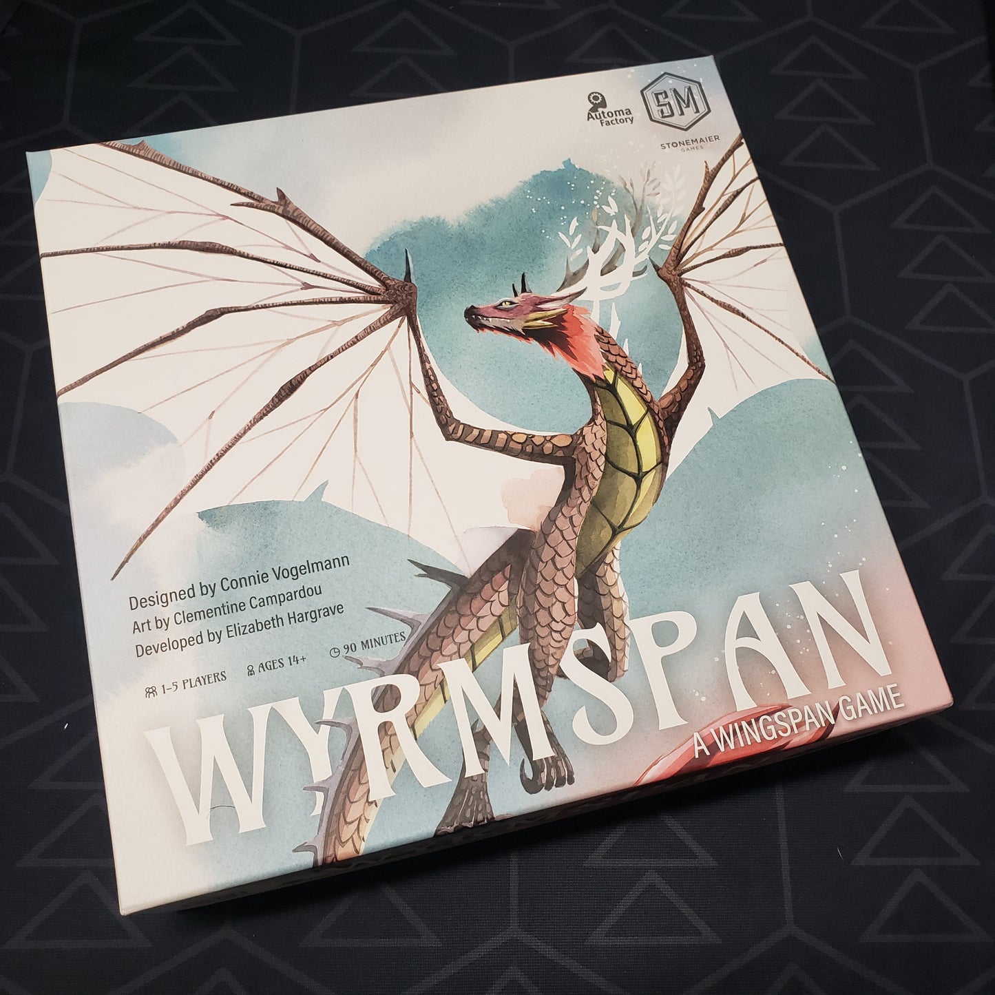 Image shows the front cover of the box of the Wyrmspan board game