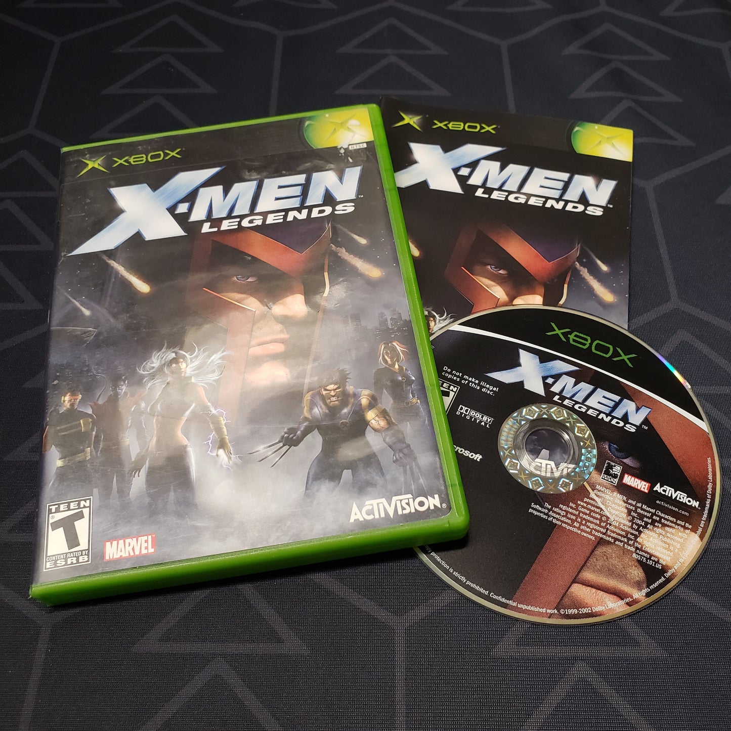 Image shows the case, manual and disc for the video game X-Men Legends for the original Xbox