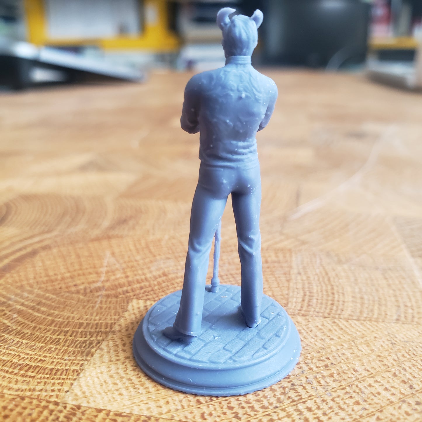 Image is a photo of a 3D printed tiefling noble gaming miniature printed in-house at All Systems Go