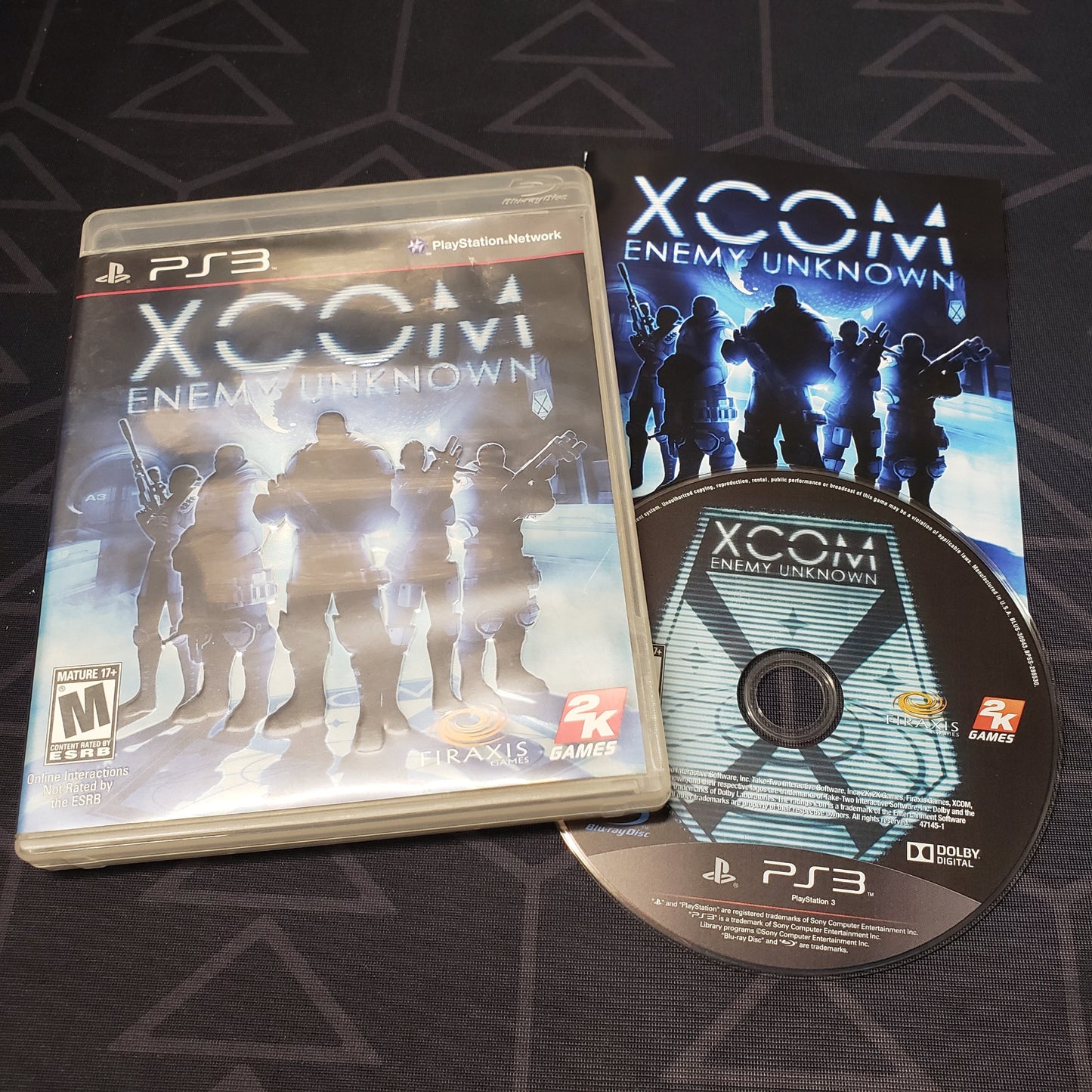 Image shows the case, manual and disc for the video game XCOM: Enemy Unknown for Playstation 3