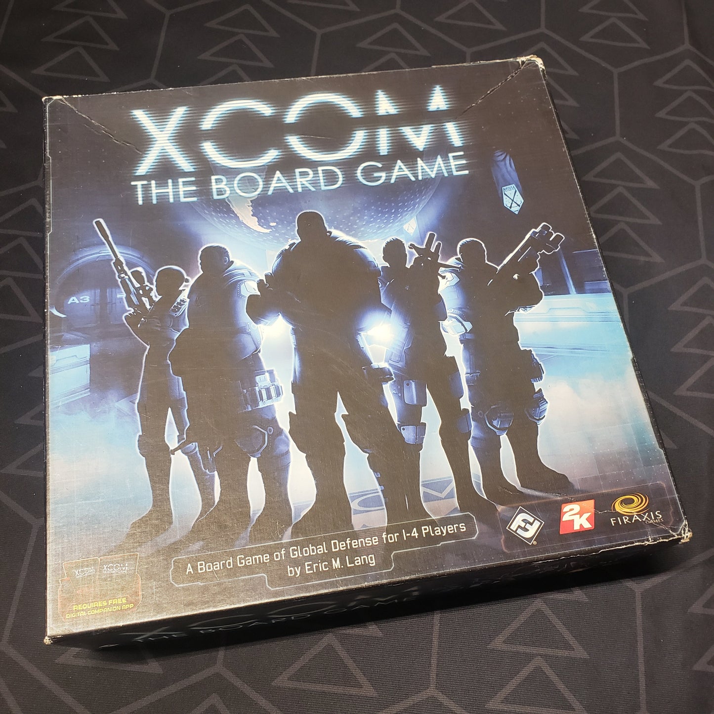 Image shows the front cover of the box of XCOM: The Board Game