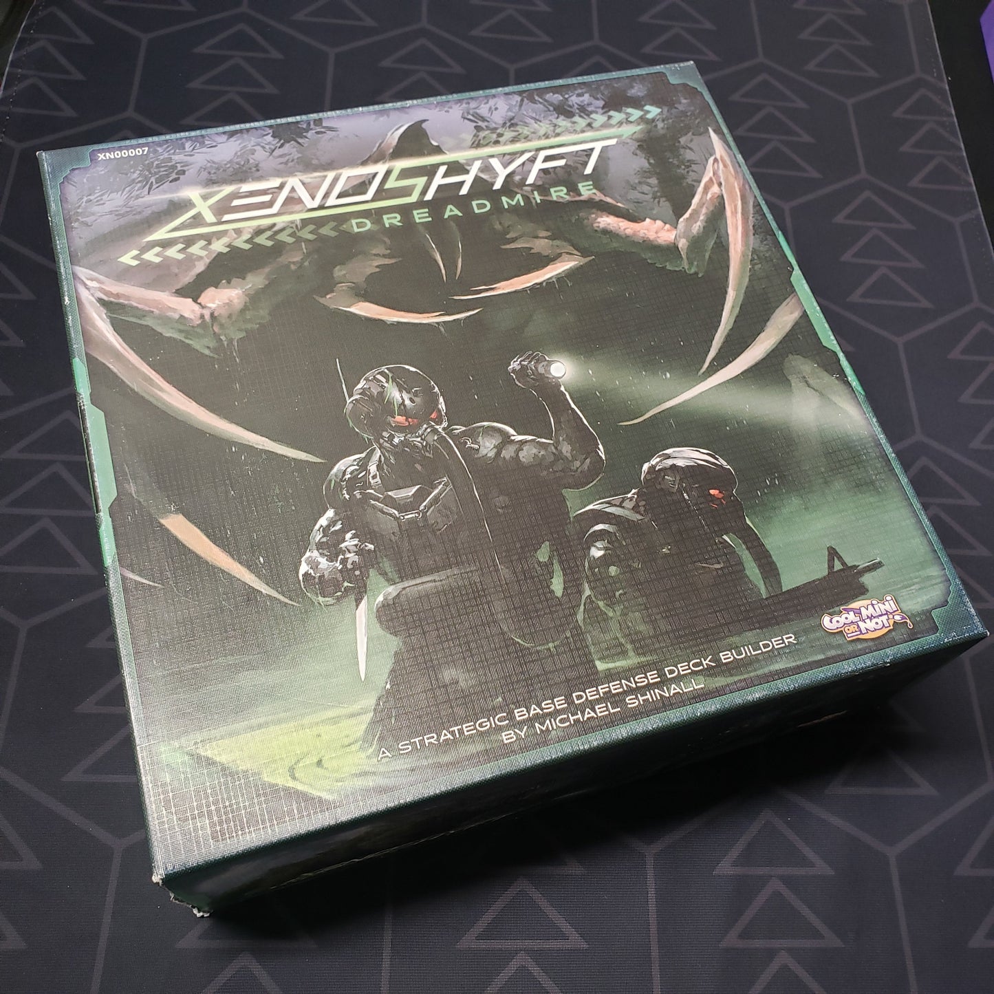 Image shows the front cover of the box of the XenoShyft: Dreadmire board game