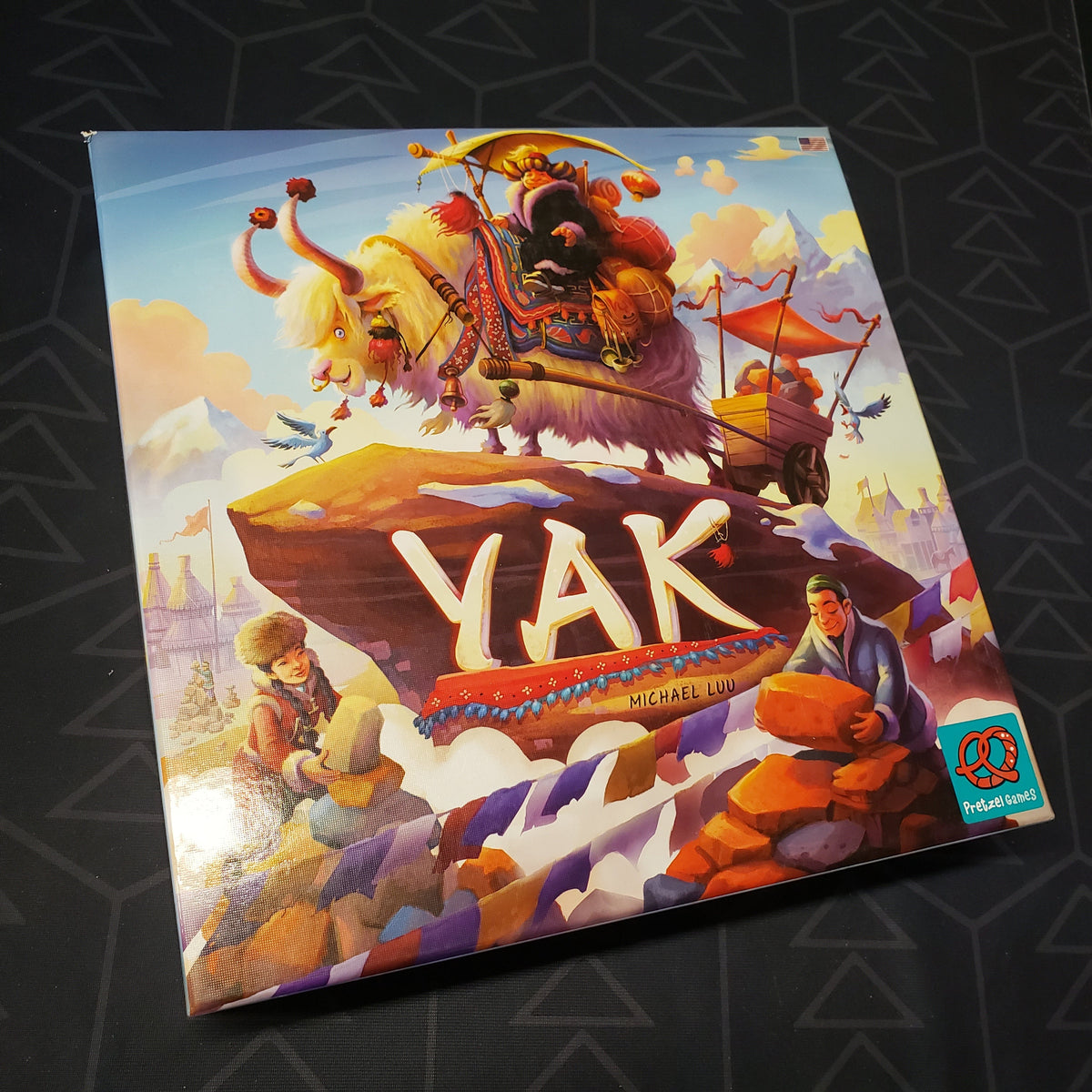 Image shows the front cover of the box for the Yak board game
