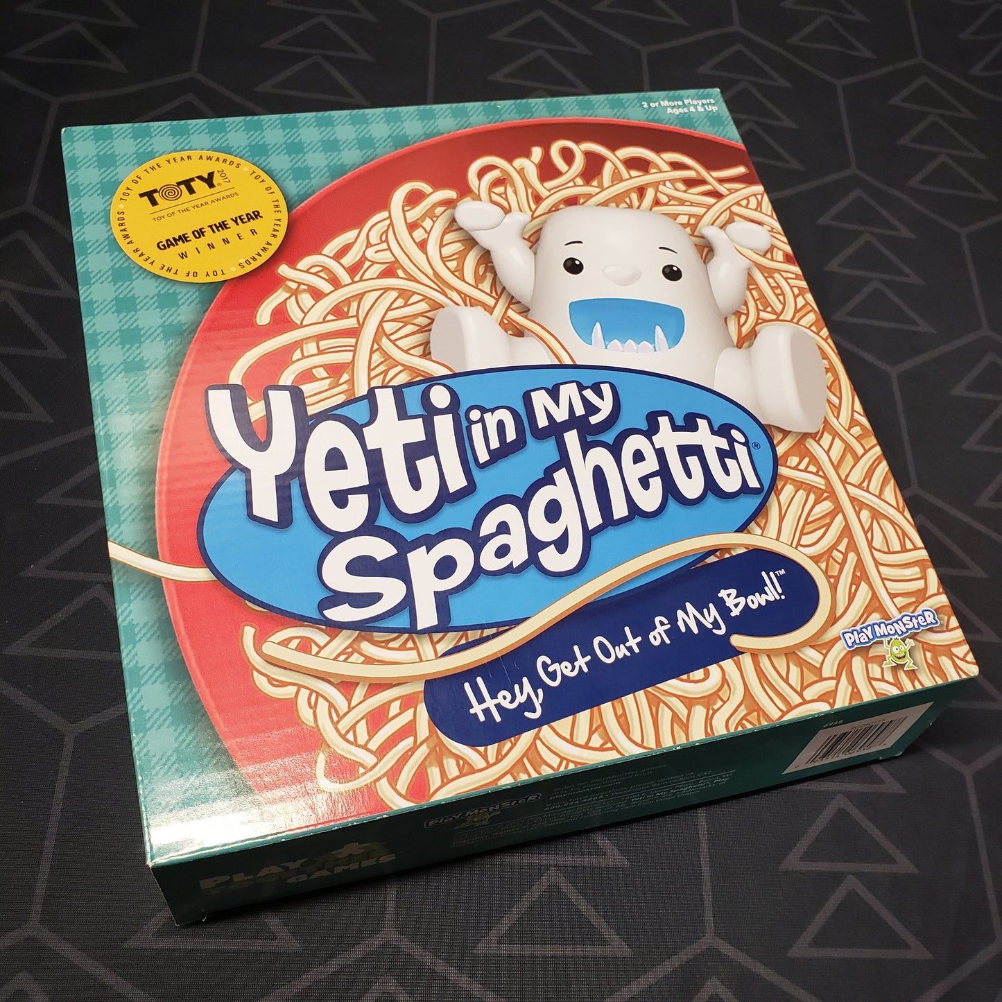 Image shows the front cover of the box for the Yeti in My Spaghetti board game