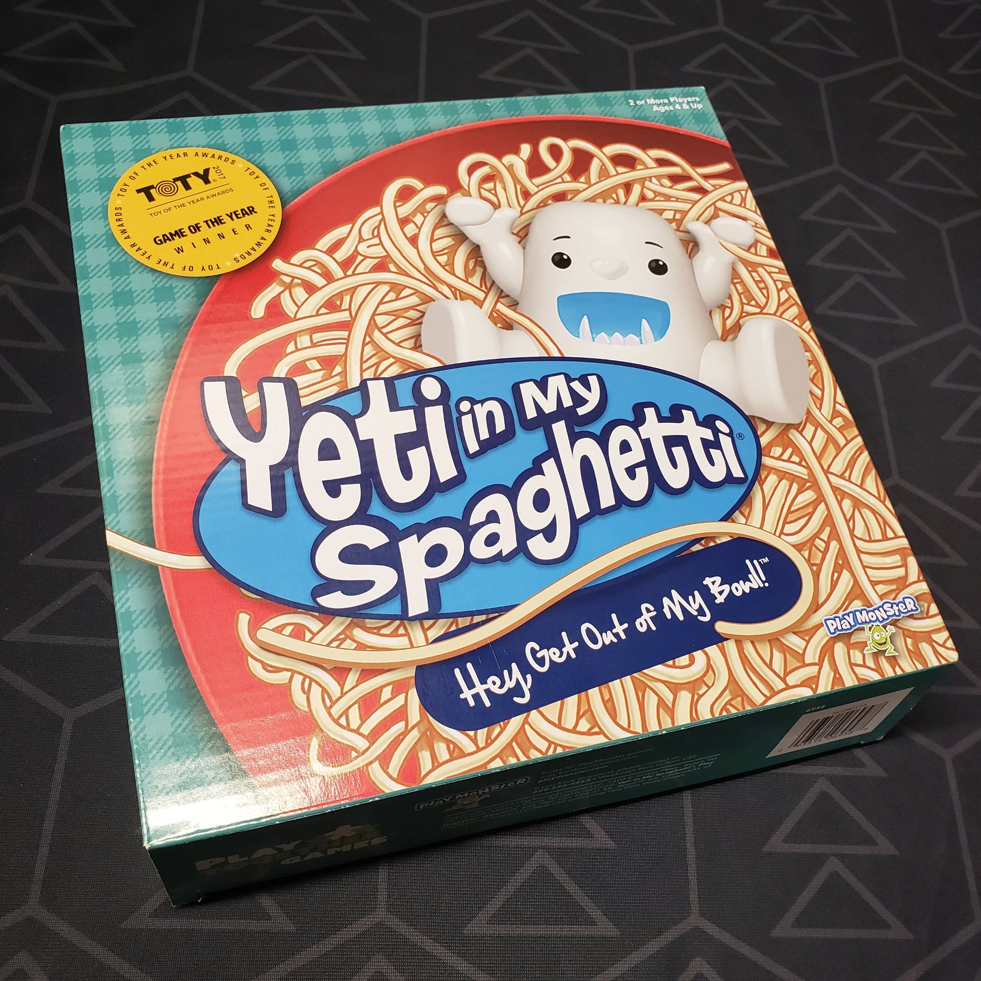 Image shows the front cover of the box for the Yeti in My Spaghetti board game
