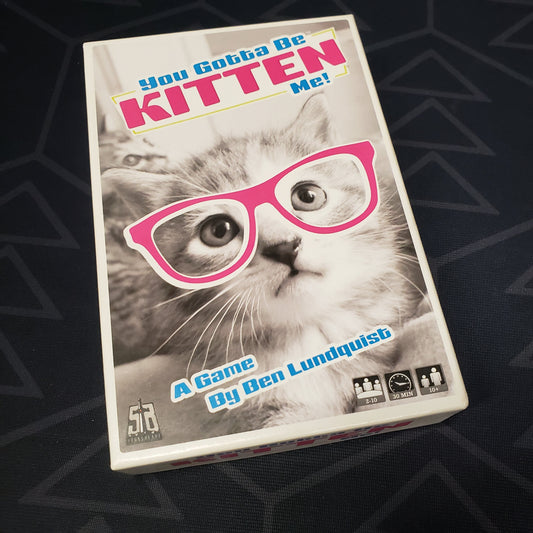Image shows the front cover of the box of the You Gotta Be Kitten Me! card game