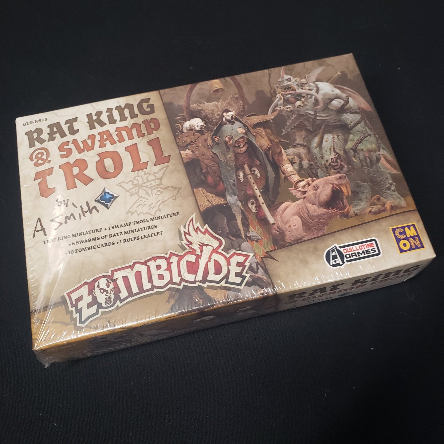 Image shows the front of the box for the Rat King & Swamp Troll expansion for the board game Zombicide: Black Plague