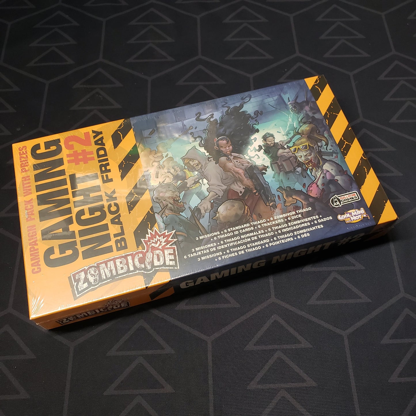 Image shows the front cover of the box of the Gaming Night #2: Black Friday expansion for the board game Zombicide