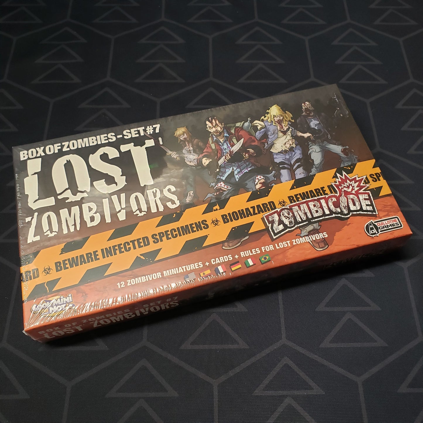 Image shows the front cover of the box of the Set #7: Lost Zombivors expansion for the board game Zombicide