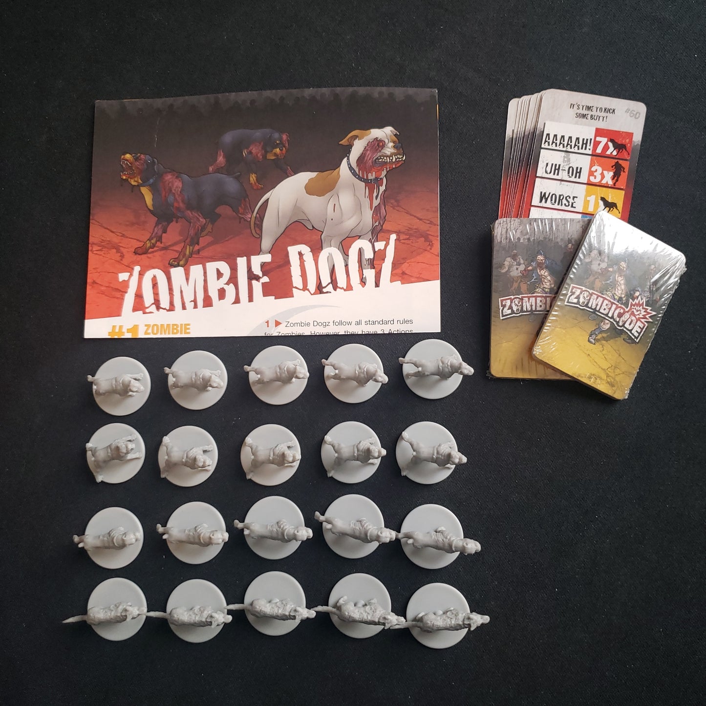 Image shows the miniatures and cards for the Zombie Dogz expansion for the board game Zombicide