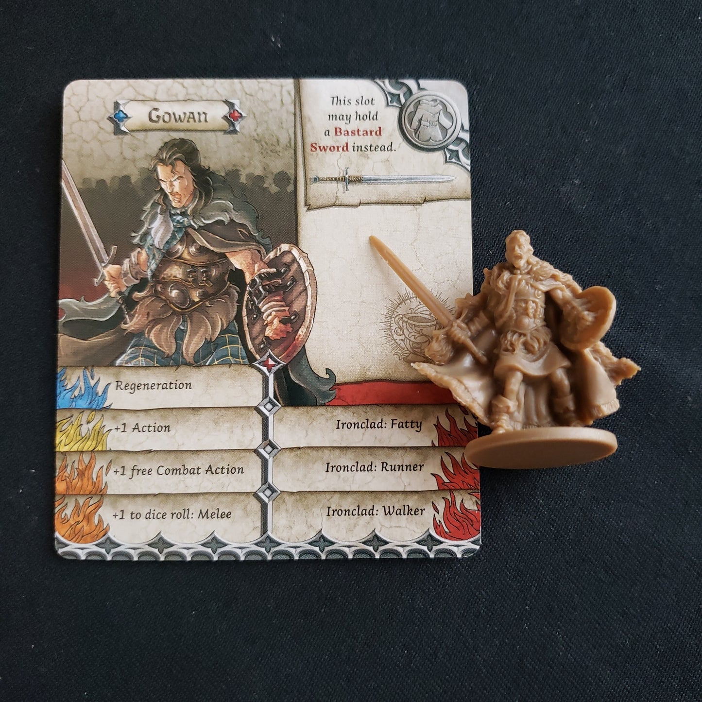 Image shows the miniature and card for the Gowan promo character pack for the board games Zombicide: Black Plague & Green Horde