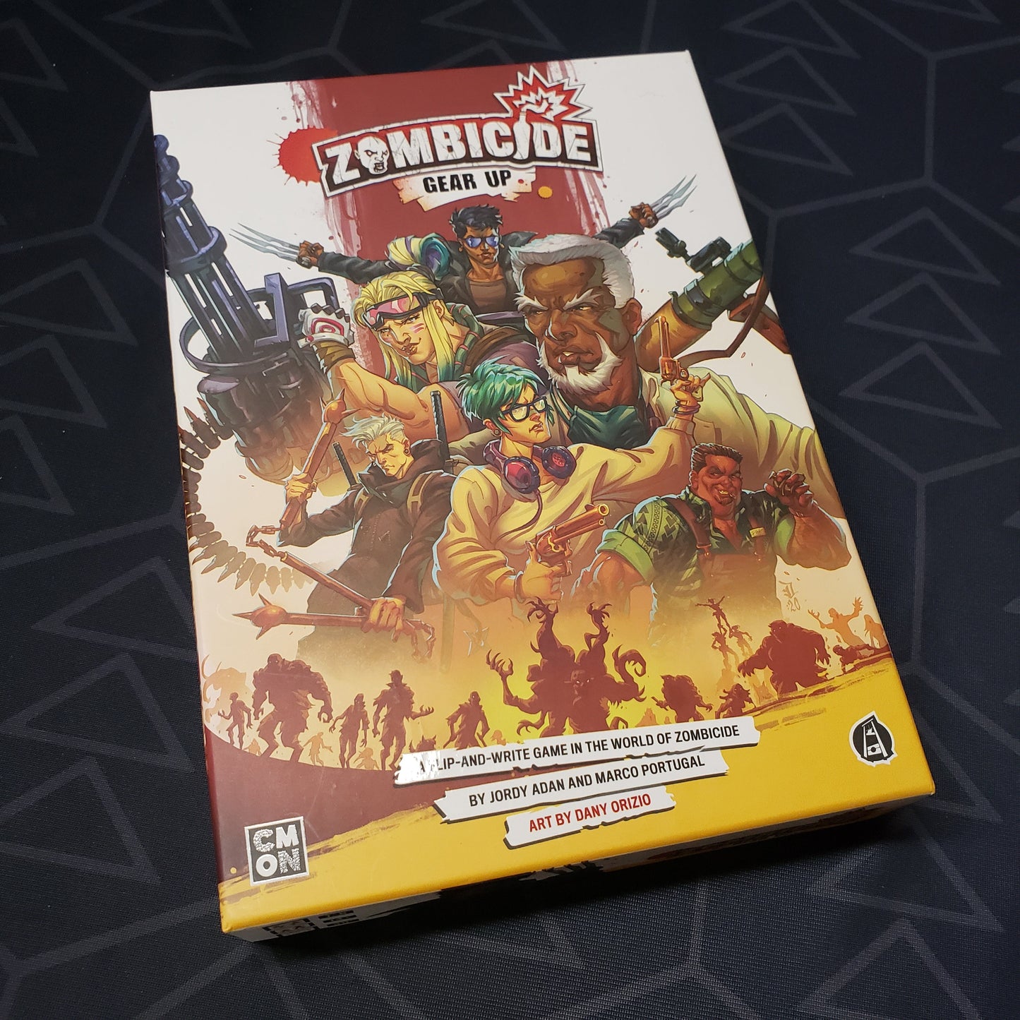 Image shows the front cover of the box for the Zombicide: Gear Up board game