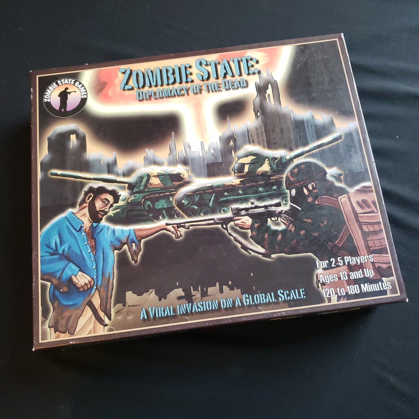 Image shows the front cover of the box of the board game Zombie State: Diplomacy of the Dead