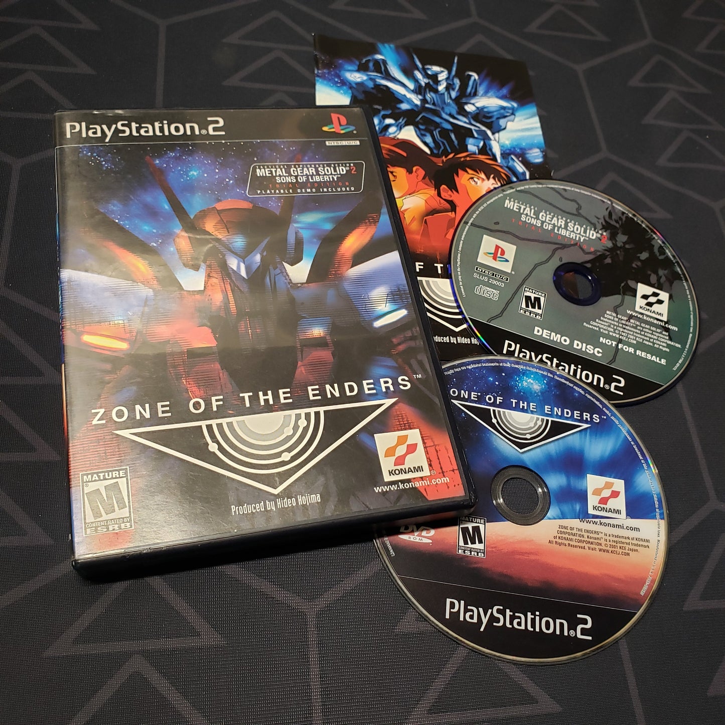 Image shows the case, manual and two discs for the video game Zone of the Enders for Playstation 2