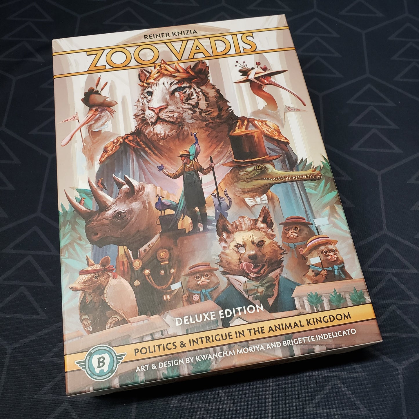 Image shows the front cover of the Deluxe Edition box for the board game Zoo Vadis