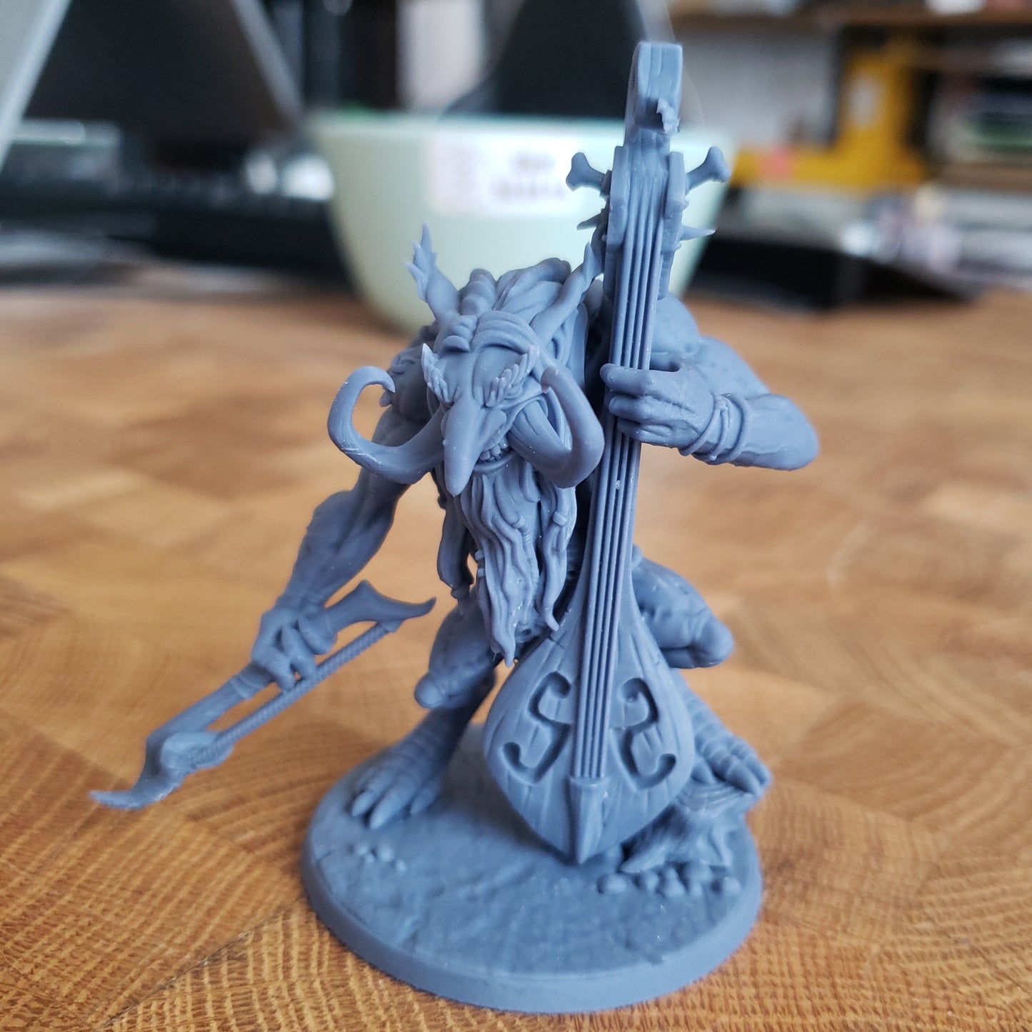 Image shows an example of a 3D printed cellist troll gaming miniature printed in-house at All Systems Go