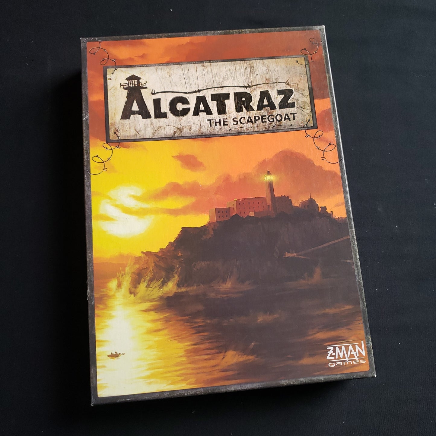 Image shows the front cover of the box of the Alcatraz: The Scapegoat board game