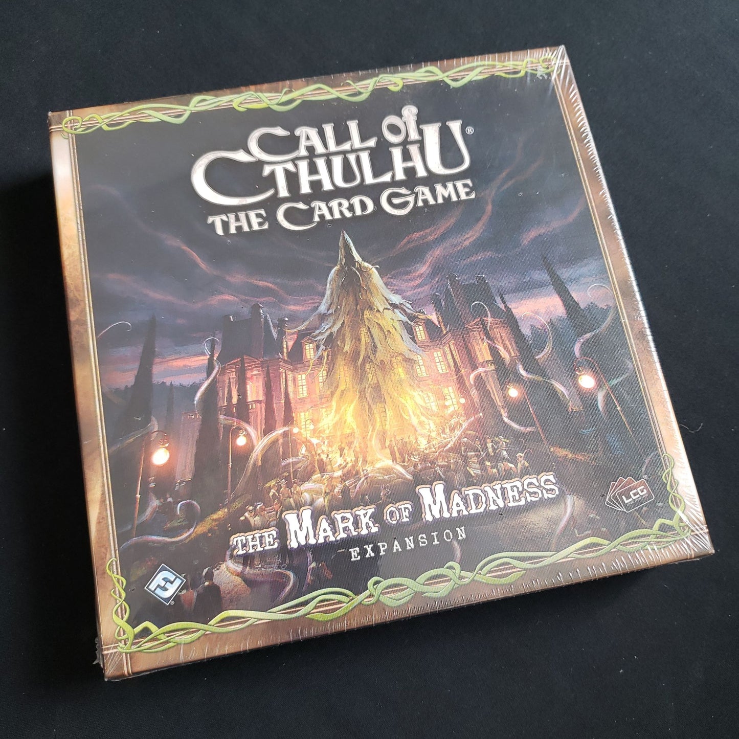 Image shows the front of the box for the Mark of Madness expansion for the Call of Cthulhu card game