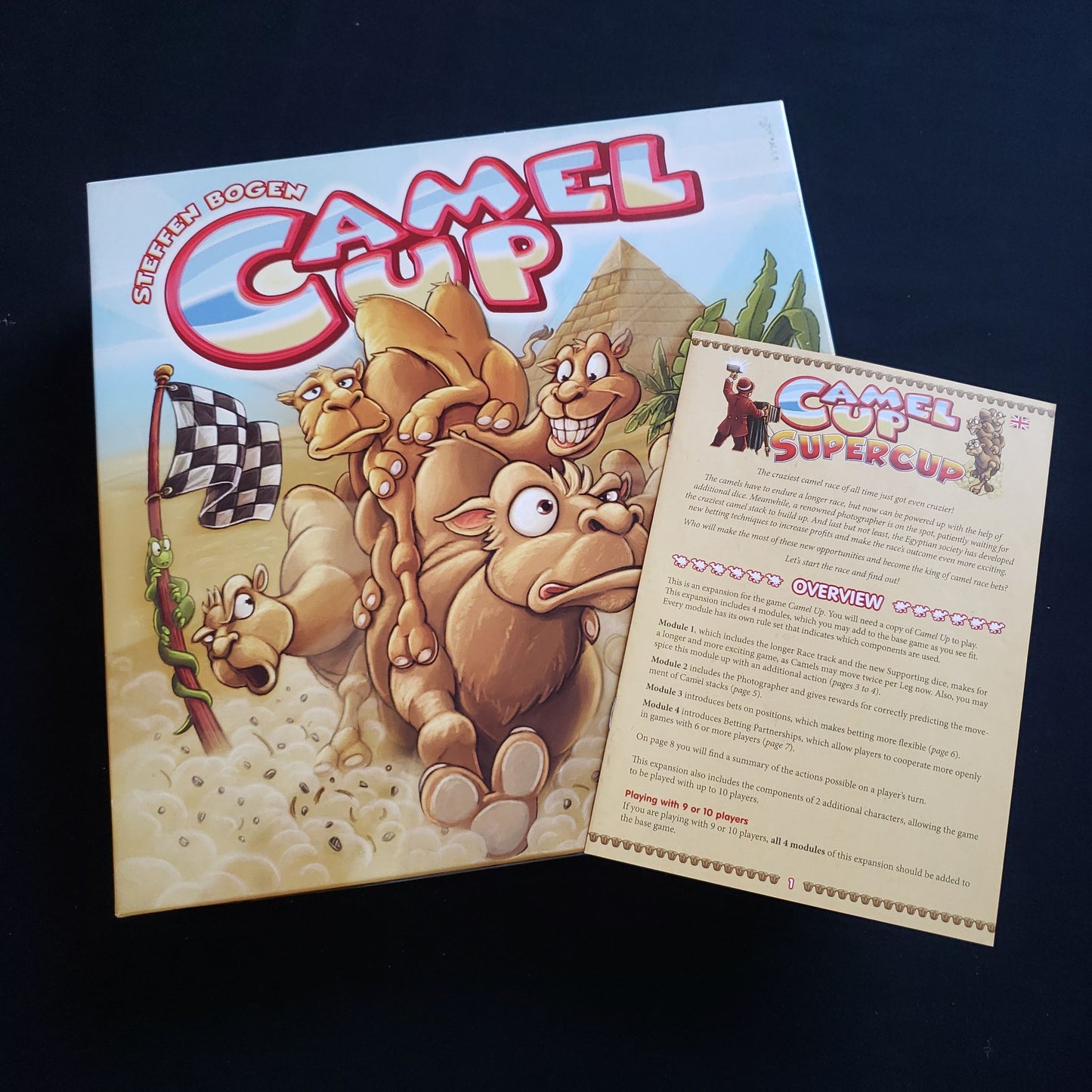 Camel Up board game - front cover of box with rules for Supercup expansion sitting on top