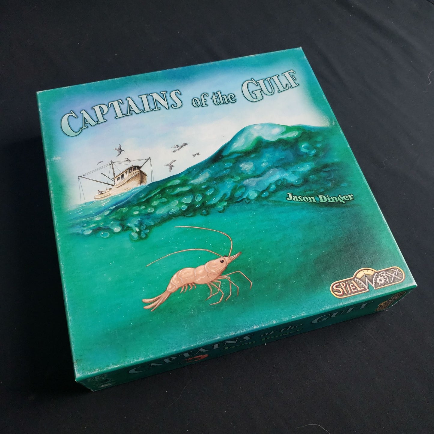 Image shows the front cover of the box of the Captains of the Gulf board game