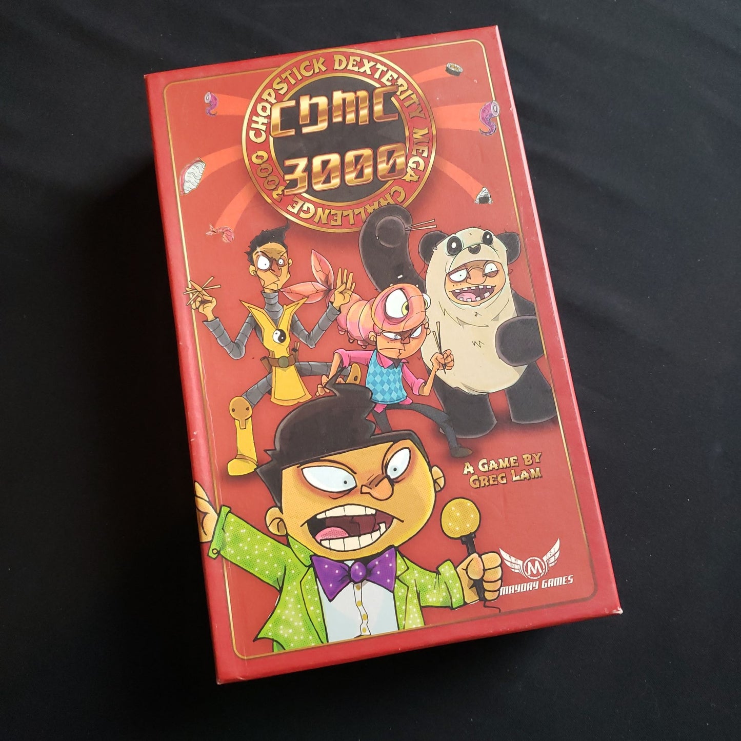 Image shows the front cover of the box of the Chopstick Dexterity mega Challenge 3000 board game