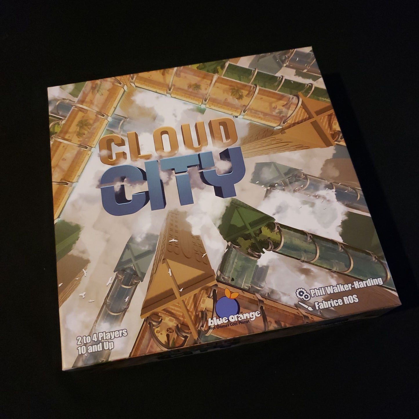 Image shows the front cover of the box of the Cloud City board game