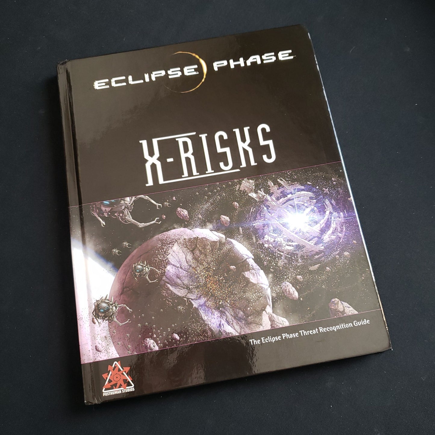 Image shows the front cover of the X-Risks book for the Eclipse Phase roleplaying game