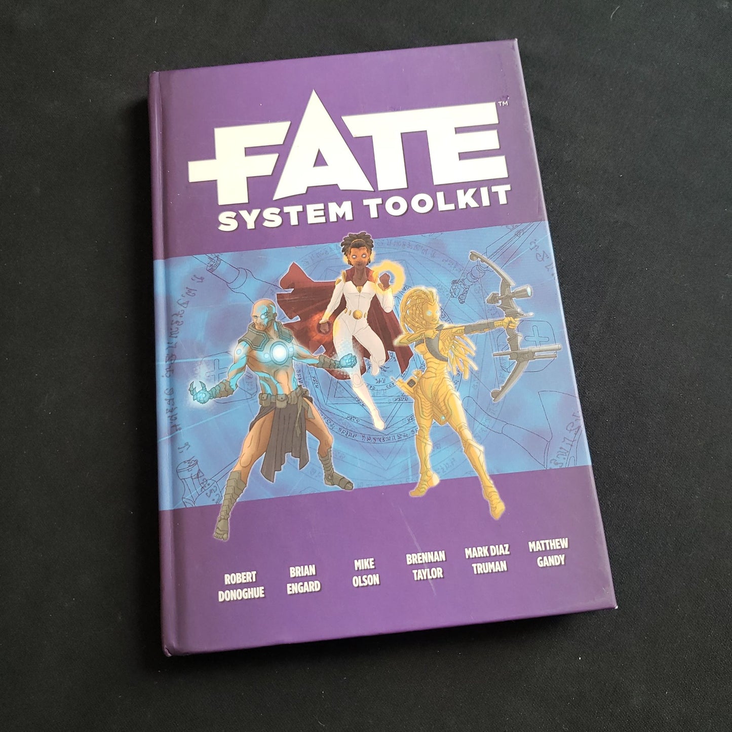 Image shows the front cover of the System Toolkit book for the Fate Core roleplaying game