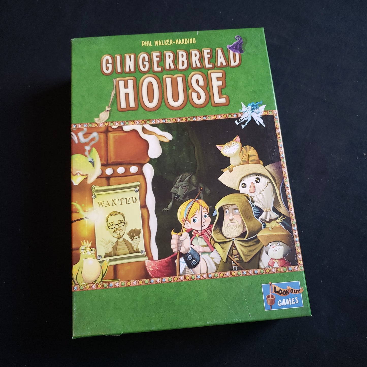 Image shows the front cover of the box of the Gingerbread House board game