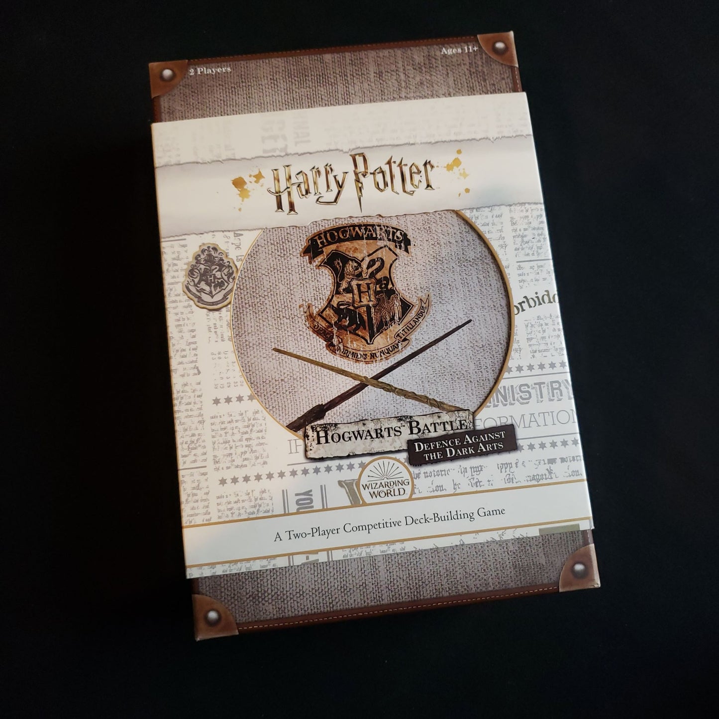 Image shows the front cover of the box of the Harry Potter Hogwarts Battle: Defence Against the Dark Arts card game
