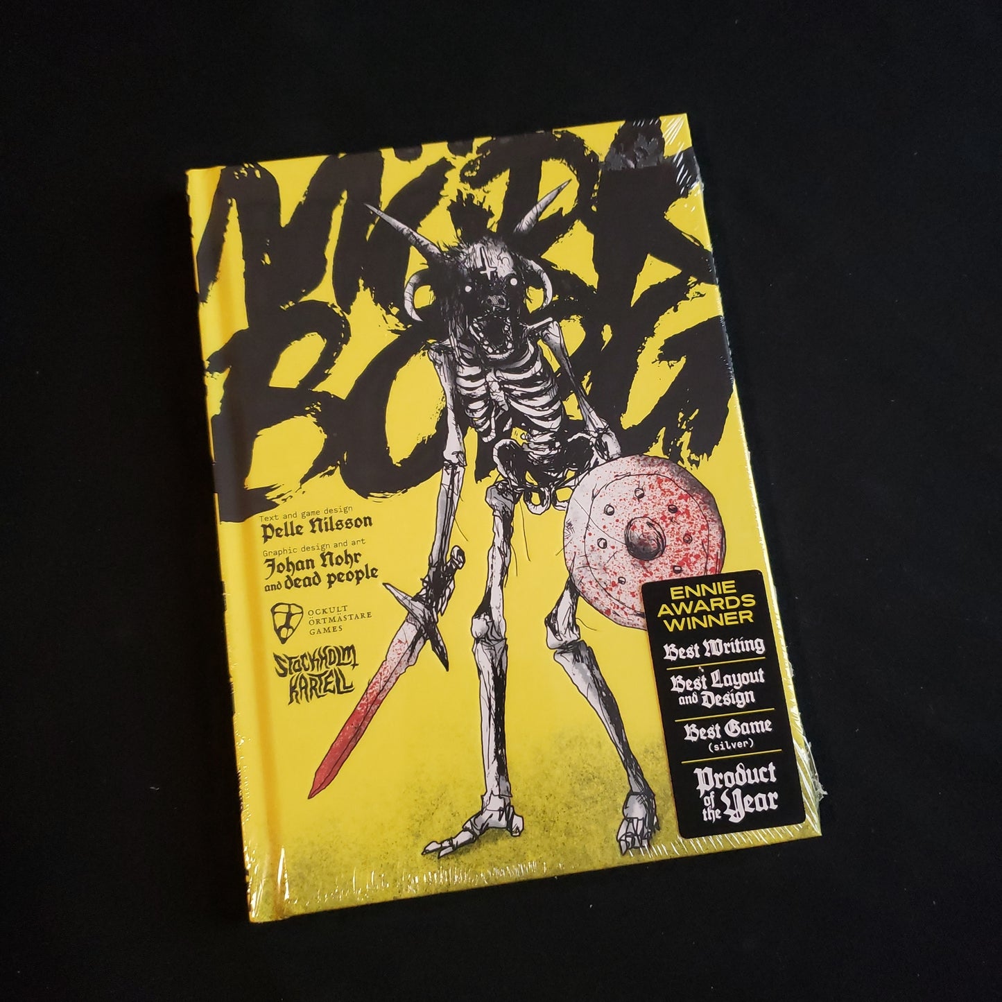 Image shows the front cover of the core rule book for the Mork Borg roleplaying game