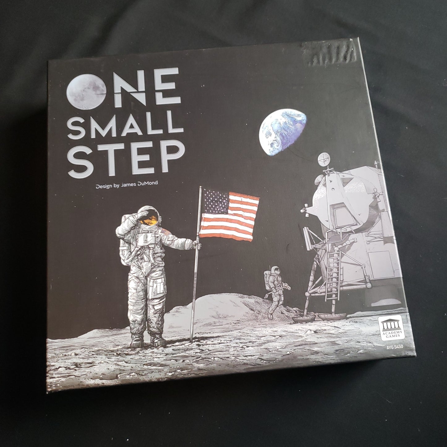 Image shows the front cover of the box of the One Small Step board game