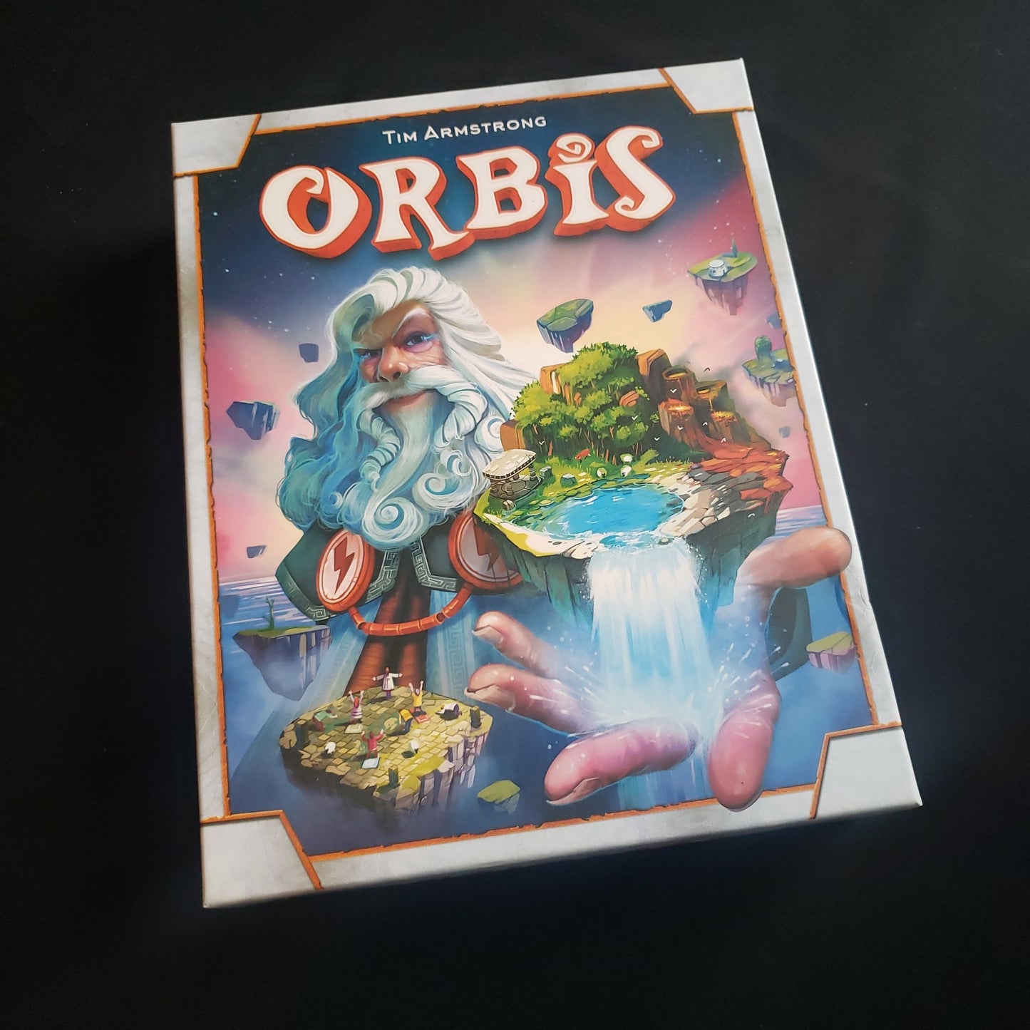 Image shows the front cover of the box of the Orbis board game