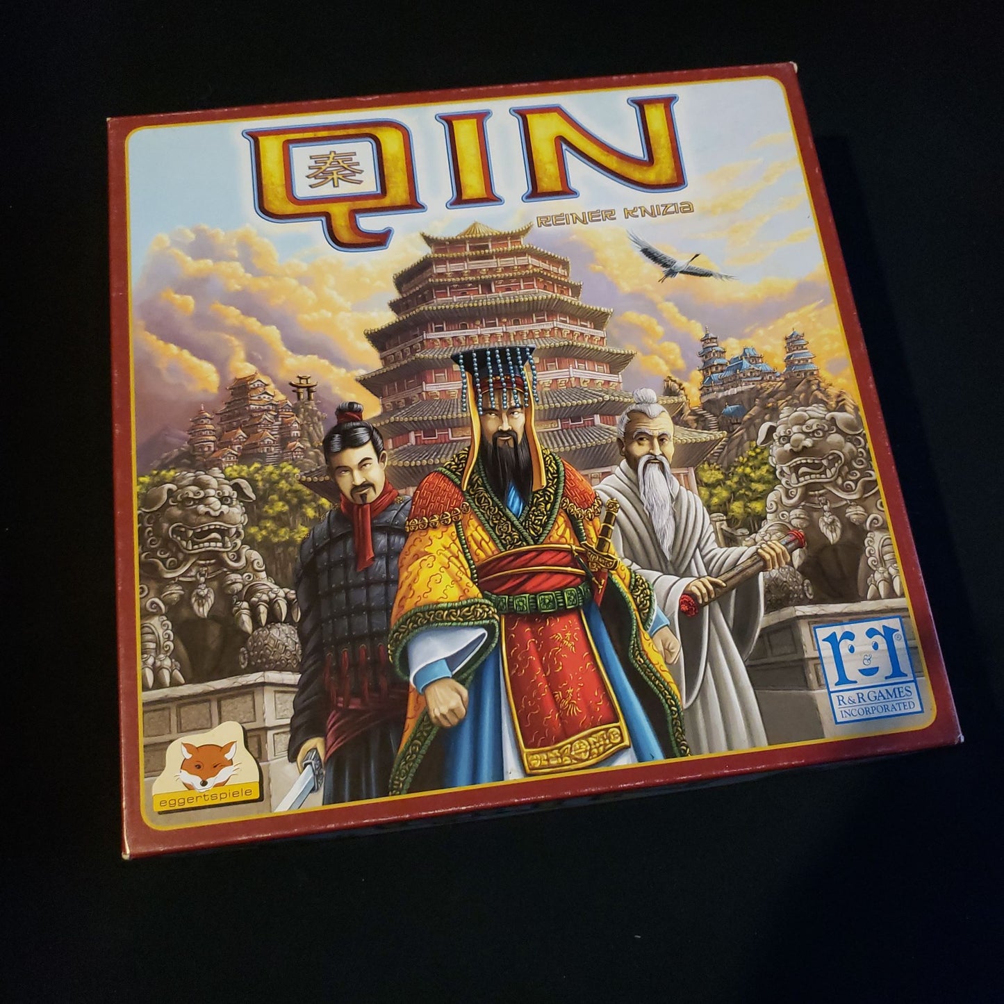 Image shows the front cover of the box of the Qin board game