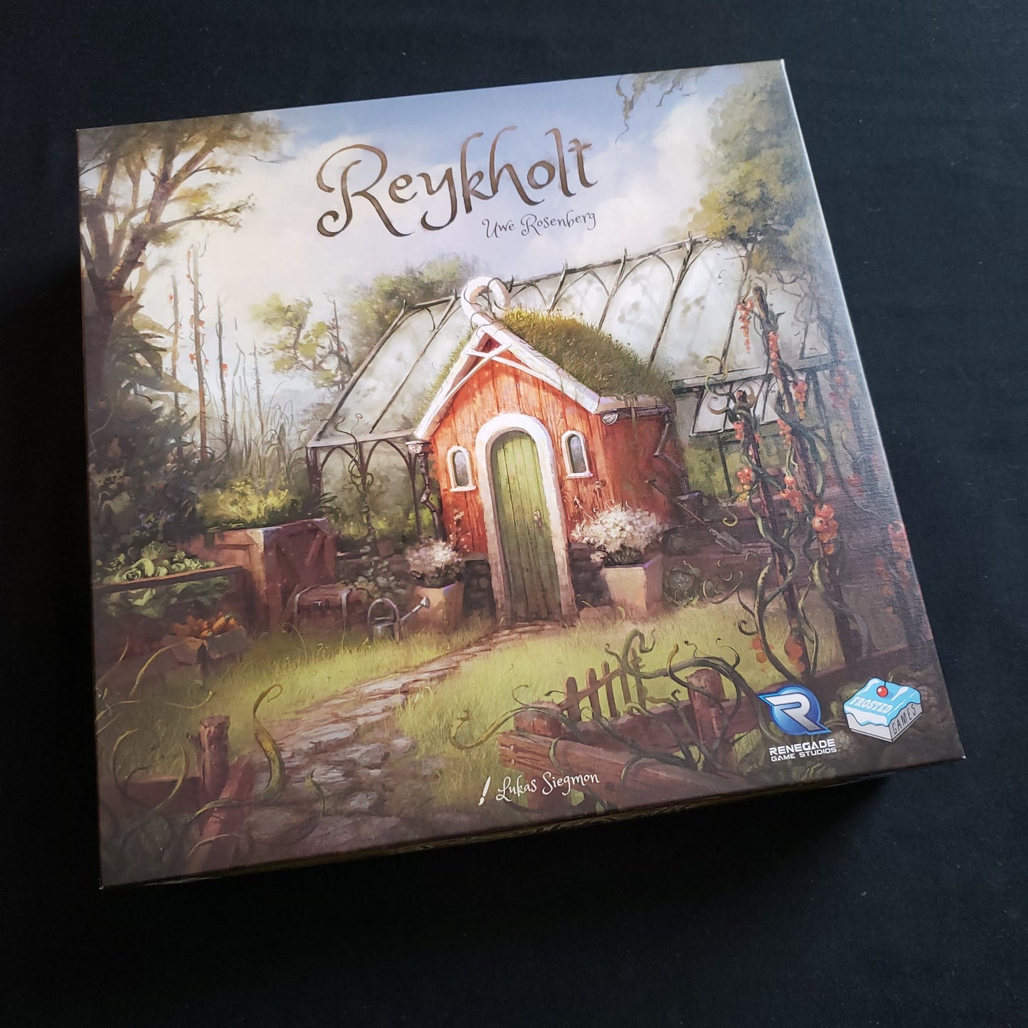 Image shows the front cover of the box of the Reykholt board game