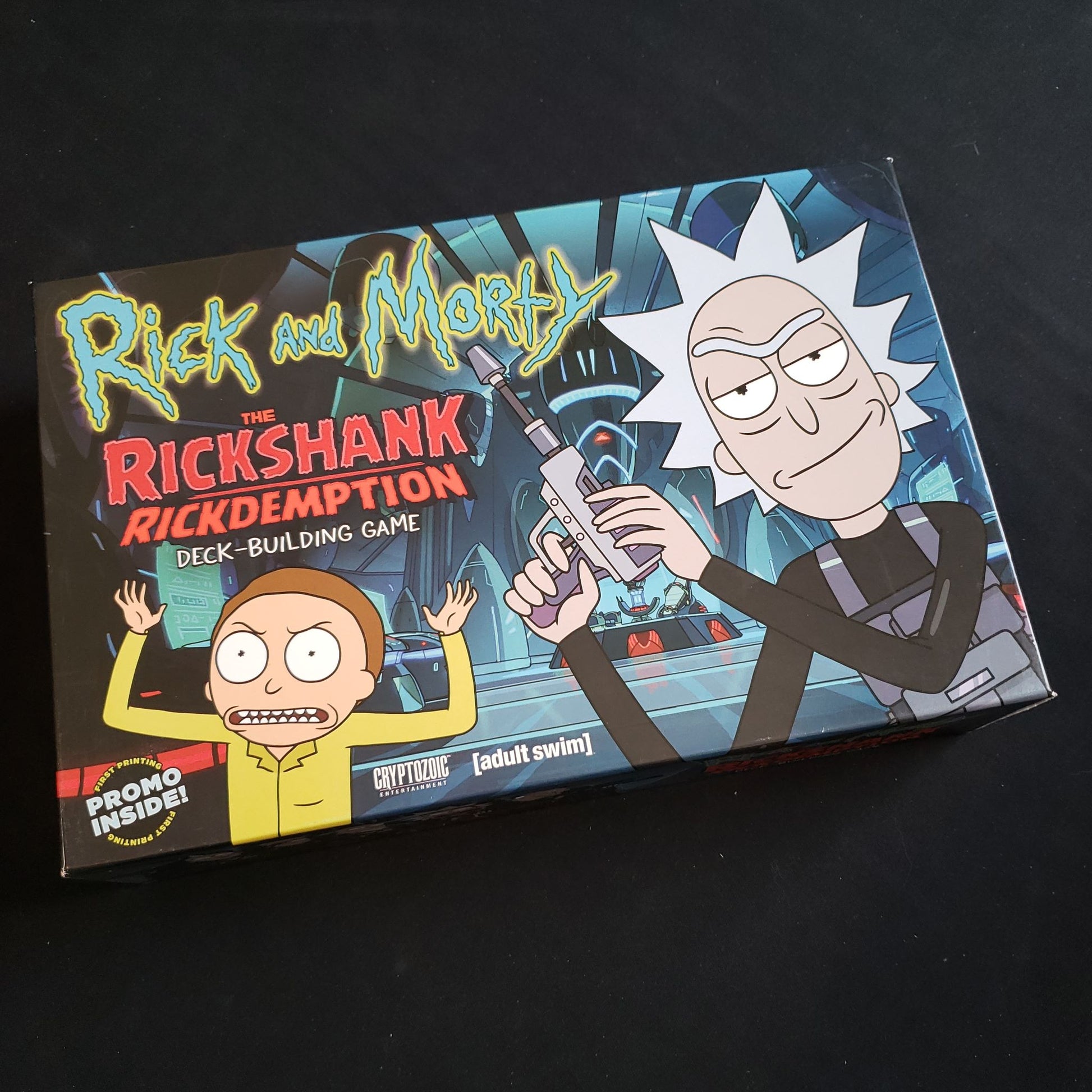 Image shows the front cover of the box of the Rick & Morty: The Rickshank Rickdemption Deckbuilding Game