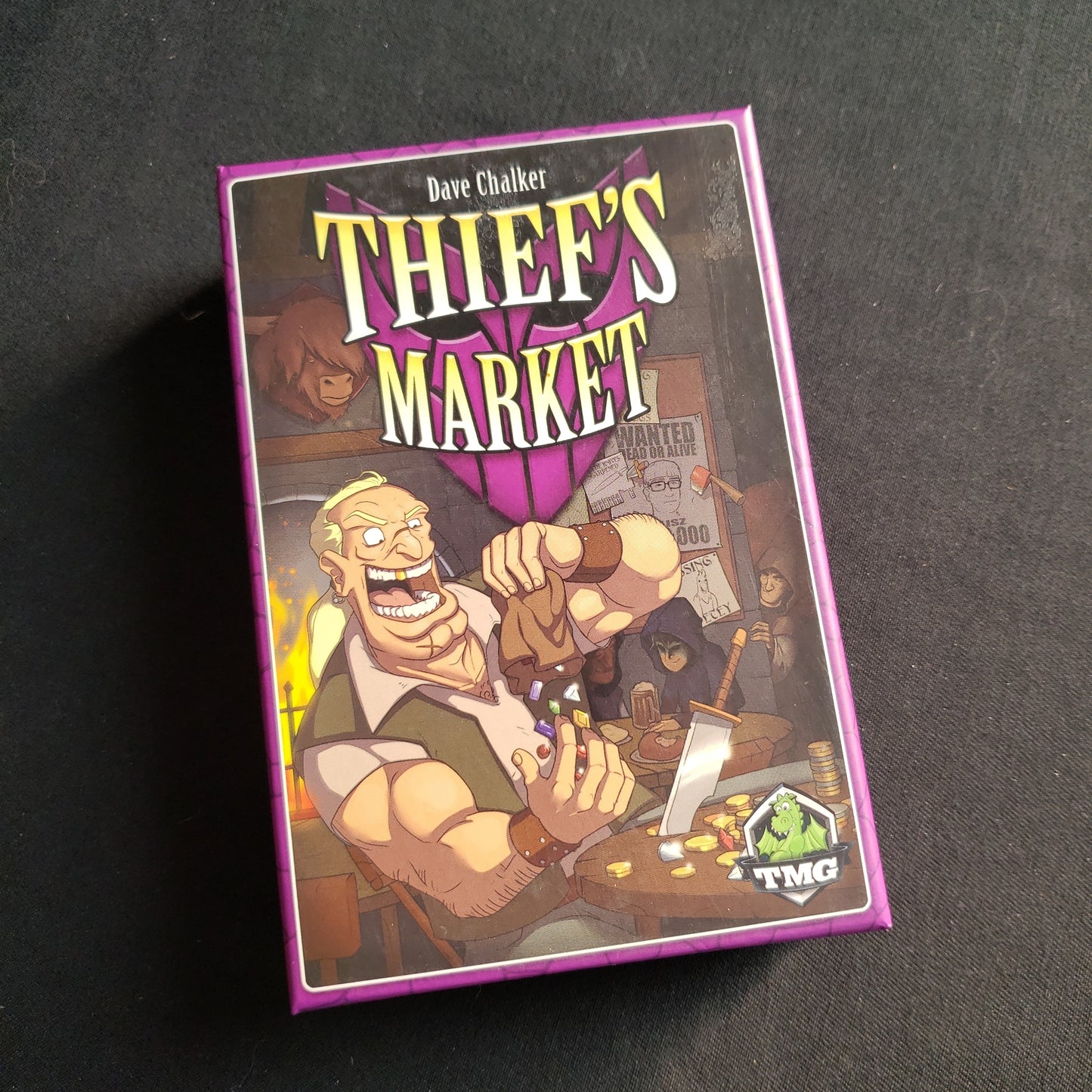 Image shows the front cover of the box of the Thief's Market card game