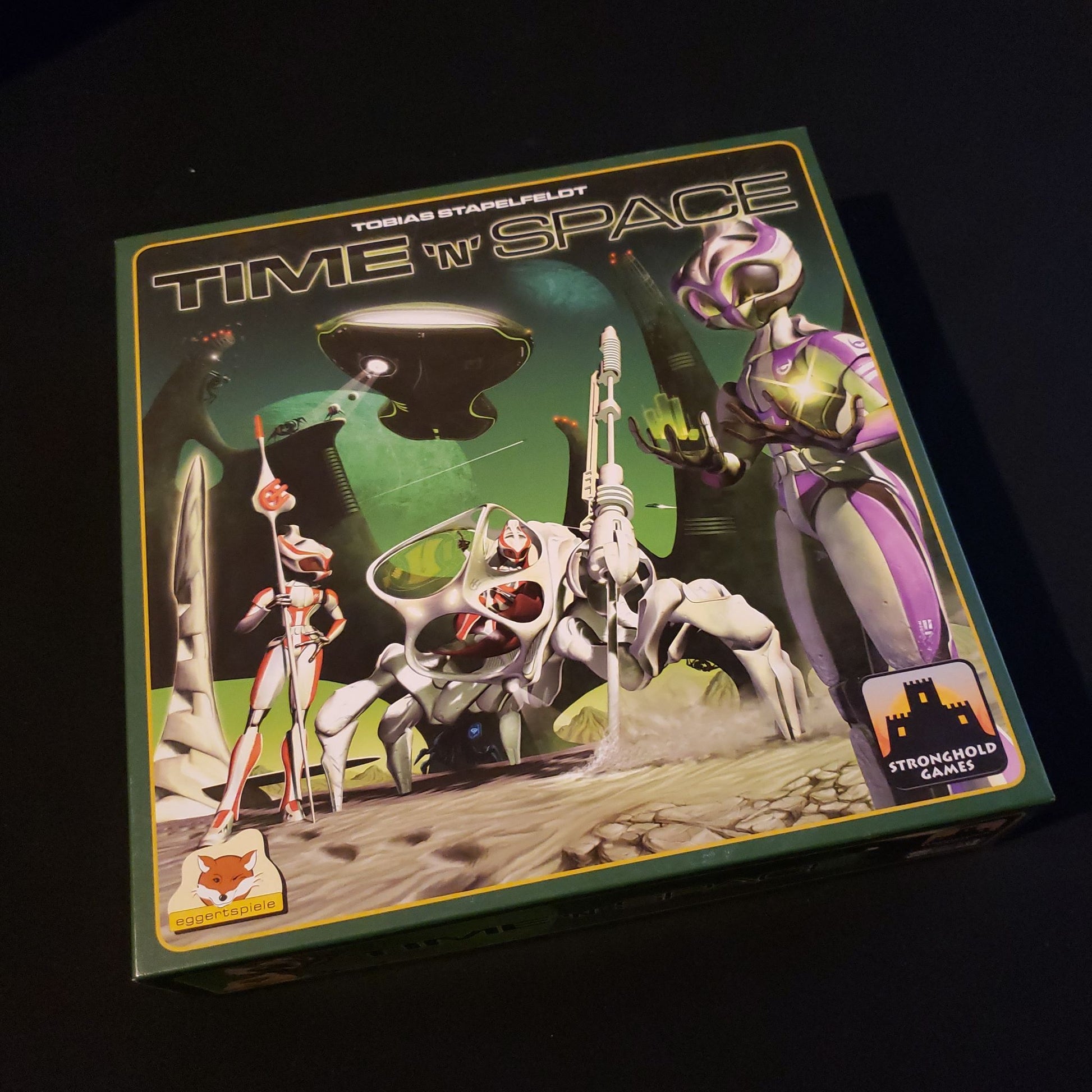 Image shows the front cover of the box for the Time N Space board game