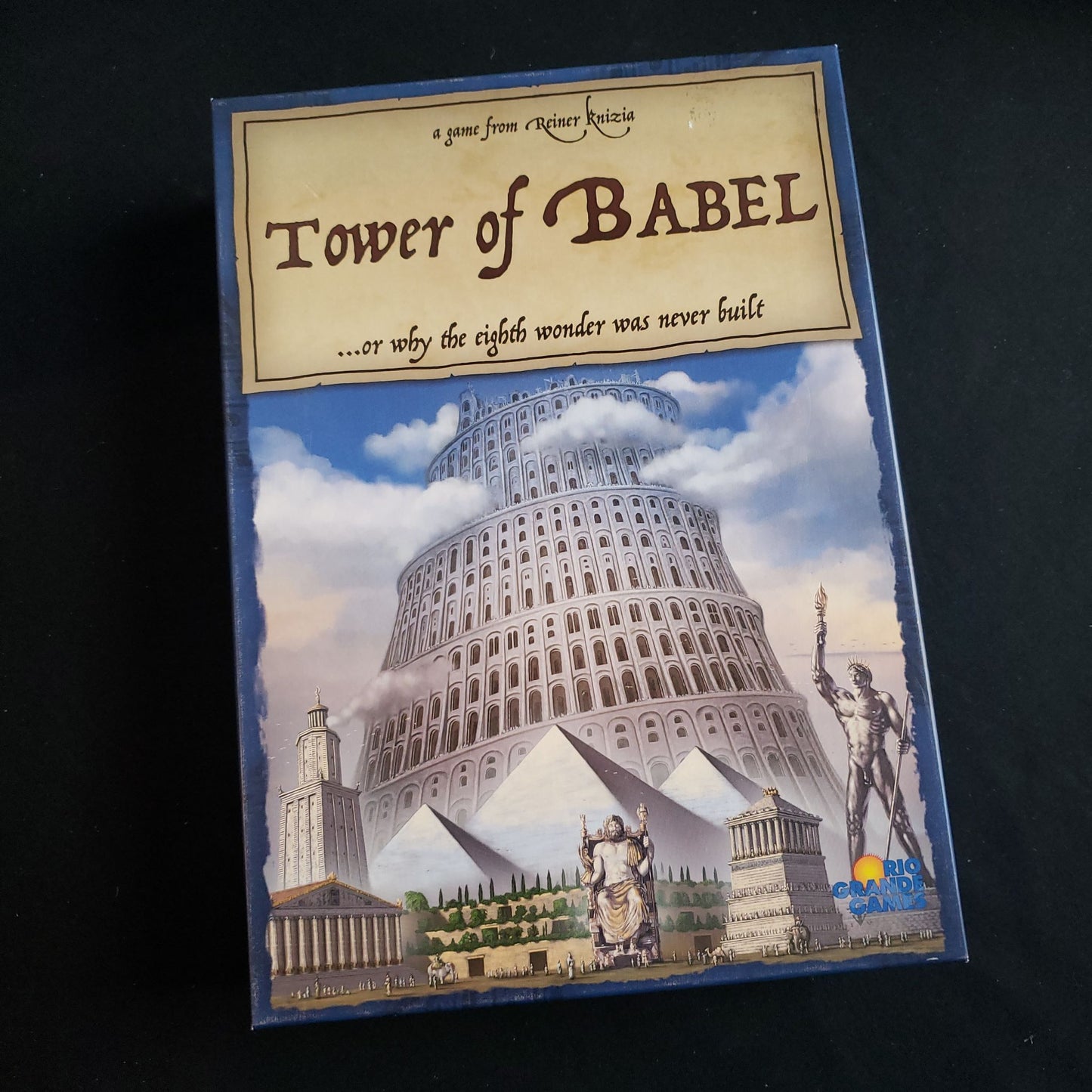 Image shows the front cover of the box of the Tower Of Babel board game