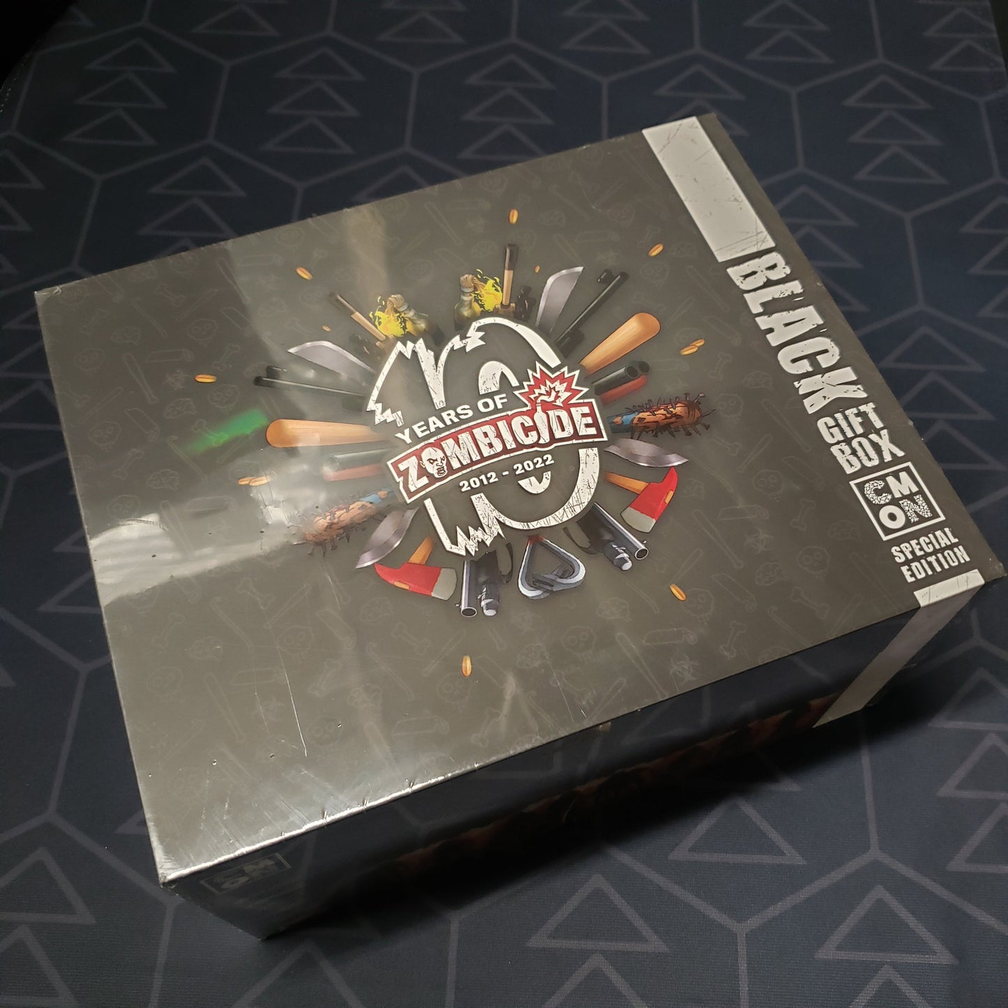 Image shows the front cover of the box of the 10 Years of Zombicide Black Gift Box