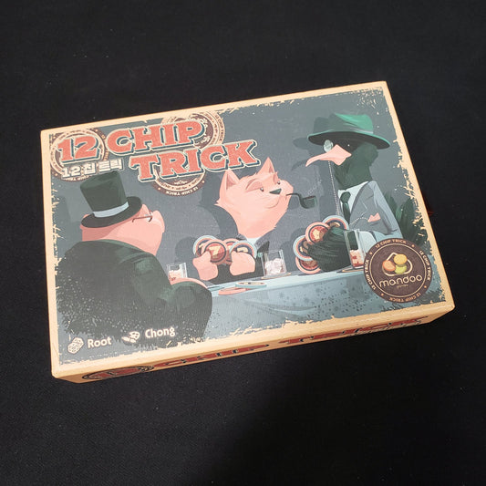 Image shows the front cover of the box of the 12 Chip Trick board game