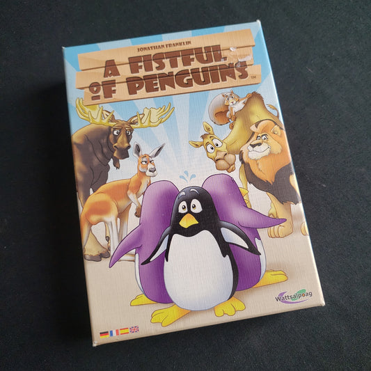 Image shows the front cover of the box of the board game A Fistful of Penguins