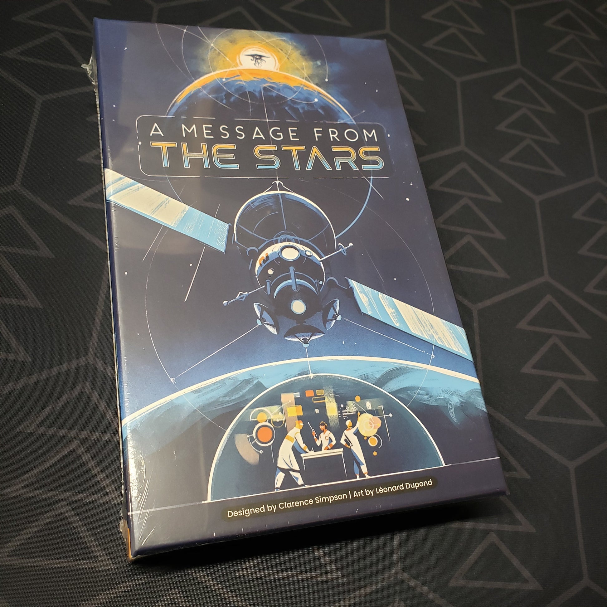 Image shows the front cover of the box for the board game A Message from the Stars