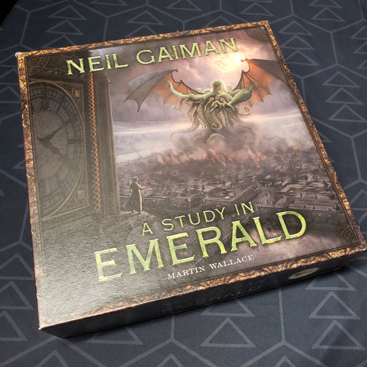 Image shows the front cover of the box for the A Study In Emerald (Second Edition) board game