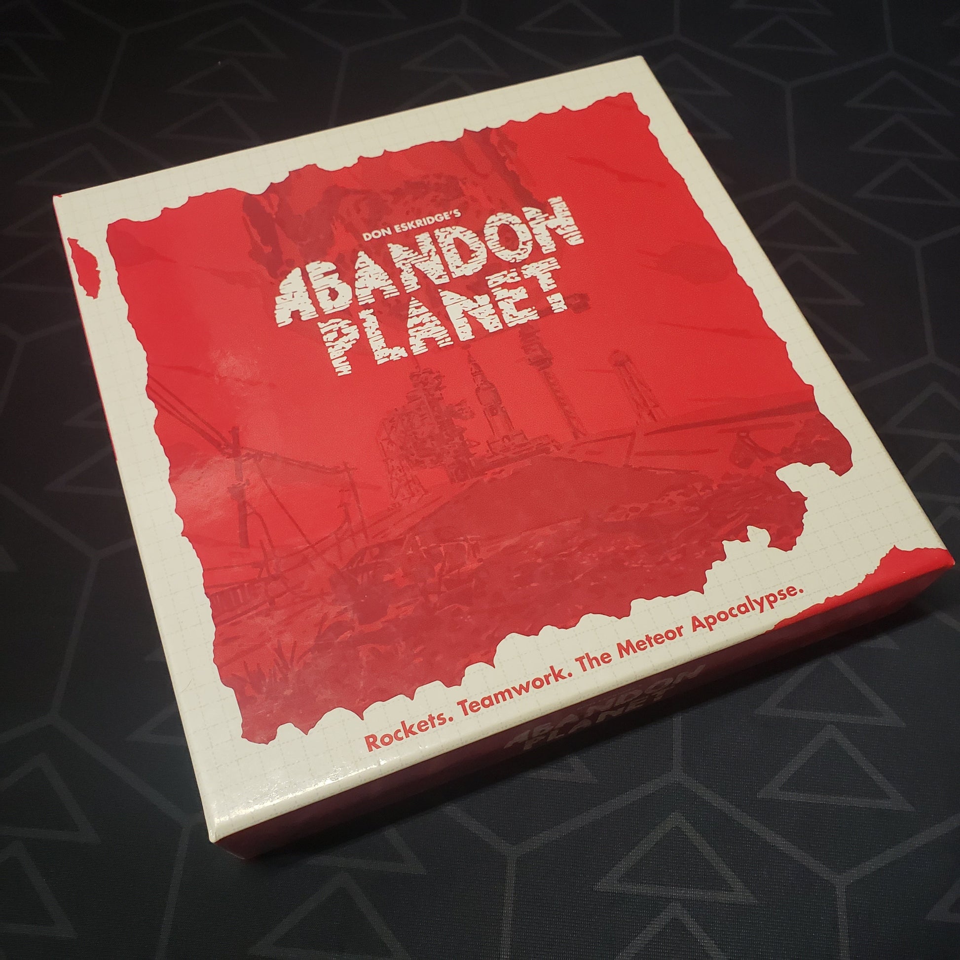 Image shows the front cover of the box of the Abandon Planet board game