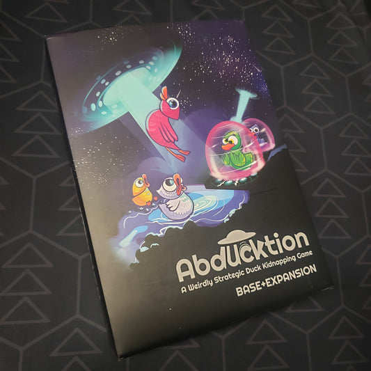 Image shows the front cover of the box for the Abducktion (Base + Expansion Edition) board game