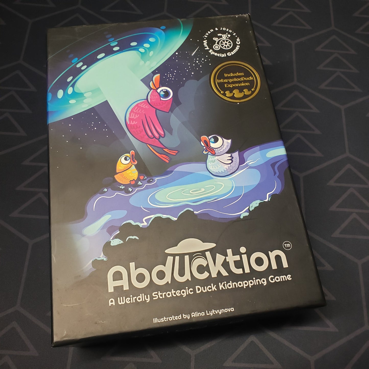 Image shows the front cover of the box for the Abducktion board game