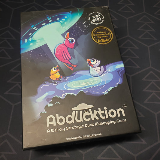 Image shows the front cover of the box for the Abducktion board game