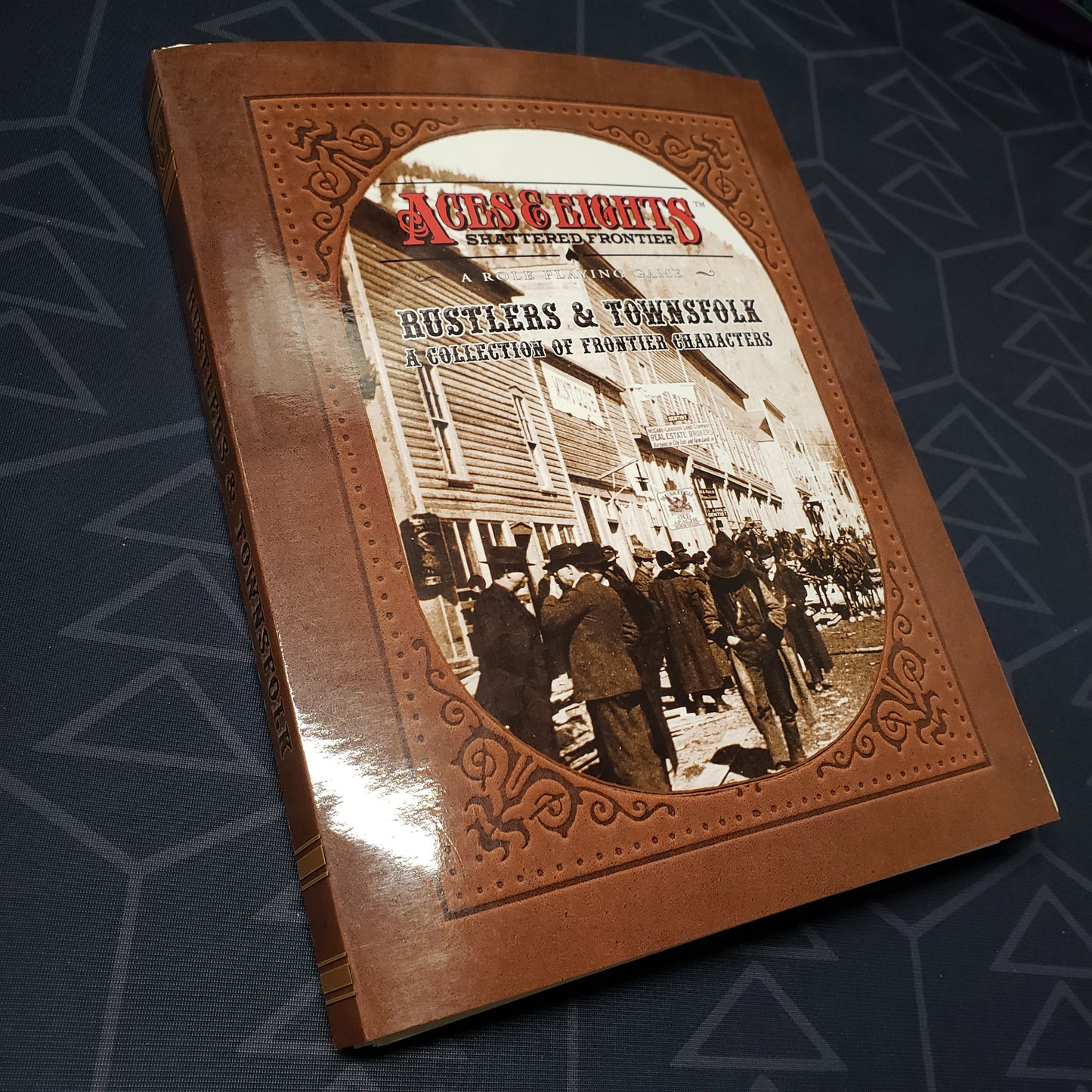 Image shows the front cover of the Rustlers & Townsfolk book for the roleplaying game Aces & Eights: Shattered Frontier